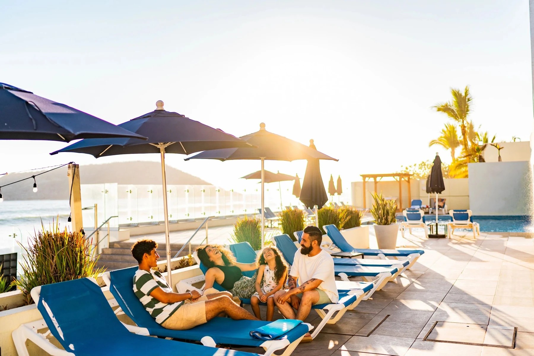 Travelers relaxing at a sunlit oceanfront resort