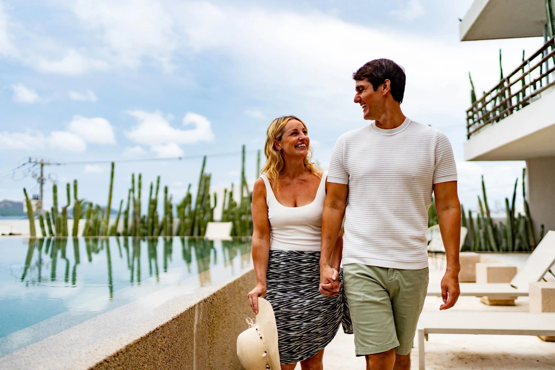 Couple walking beside a resort pool