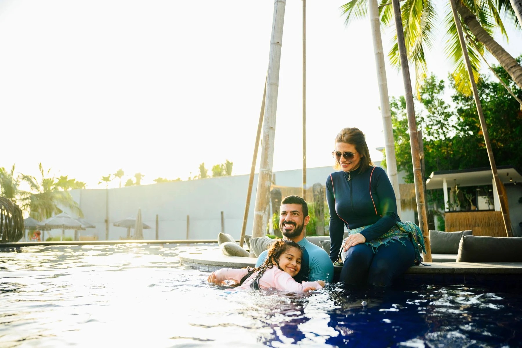 Family enjoying time together at a resort pool