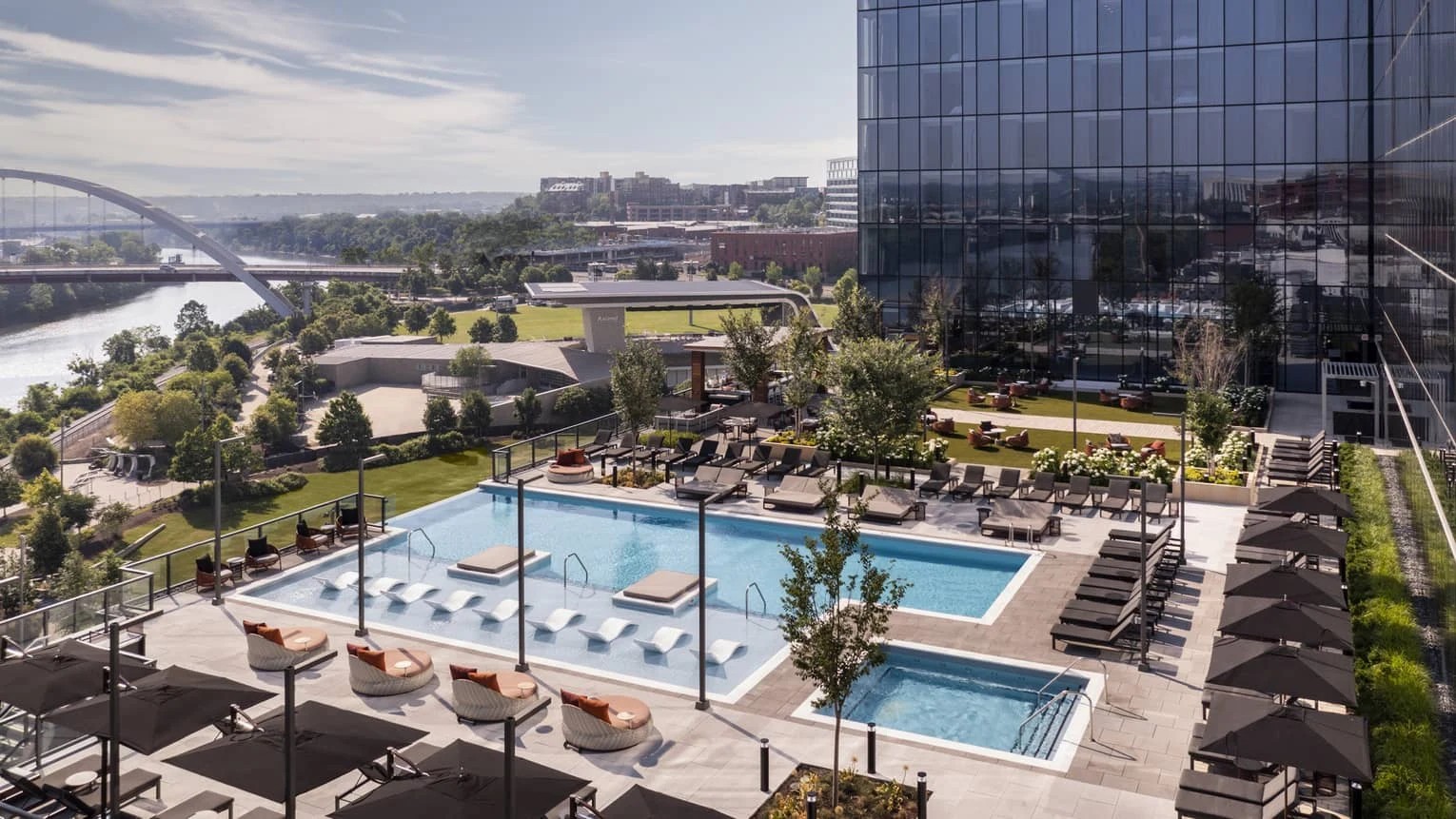 Rooftop pool overlooking a river and city skyline